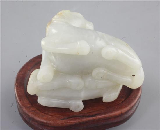 A Chinese pale celadon and russet jade group of two horses, length 6cm